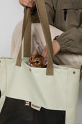 Load image into Gallery viewer, The minimalist Oatmilk white cat carrier blending seamlessly with everyday fashion.