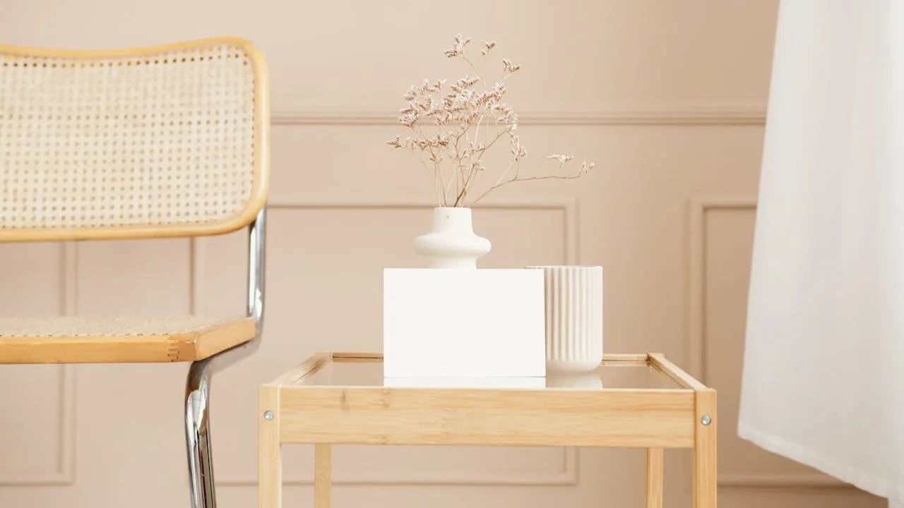 Japandi interior with natural wood side table, rattan chair and dried flowers — MeowShelf