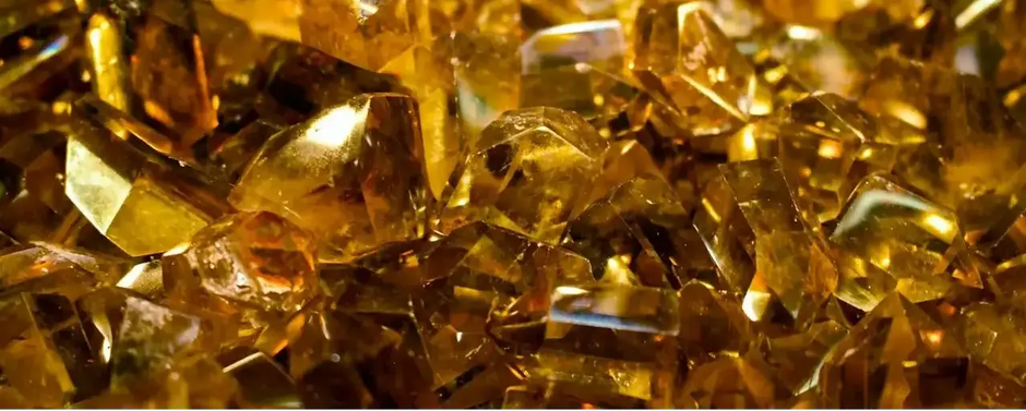 Product polished amber crystals with refined edges and golden hues, product shot