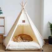 Nomad Nook Boho-Chic in canvas fabric and natural wood, side view with plush cushion and tied top, a cute cat bed.