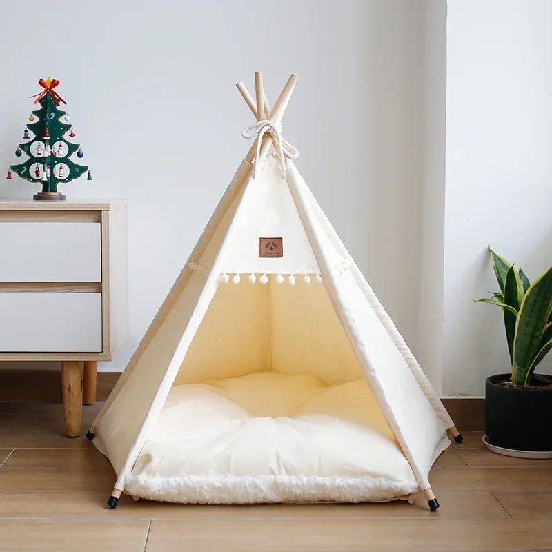 Nomad Nook Boho-Chic in canvas fabric and natural wood, angled overview with pom-pom front, an aesthetic cat bed.