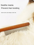 Load image into Gallery viewer, Owner easily removing floating hair with MeowShelf Kura solid wood comb.
