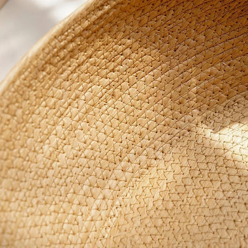 Kitten resting inside MeowShelf Breeze Nest organic boho cat basket bed.