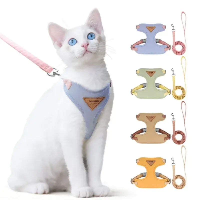 White indoor cat wearing a blue lightweight harness, with graphics highlighting the comfortable, ergonomic fit.