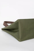 Load image into Gallery viewer, Side angle of the structured Alpine Olive green cat carrier tote standing upright.

