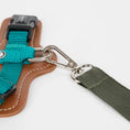 Load image into Gallery viewer, Detail of the internal safety leash hook inside the cat travel carrier for extra security.
