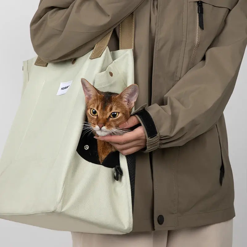 Close-up of the lightweight Oatmilk white cat travel tote worn over the shoulder.
