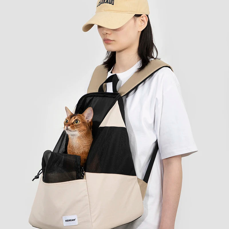 Cat looking out from well-ventilated MeowShelf Roamer soft-sided carrier.