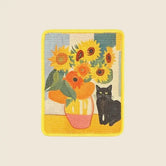 The Gallery cat wall scratcher in Golden Sunflower, sunflower vase and black cat on a sisal board