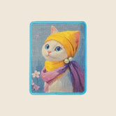 The Gallery cat wall scratcher in Pearl Muse, white kitten in yellow headscarf on a blue-framed sisal board