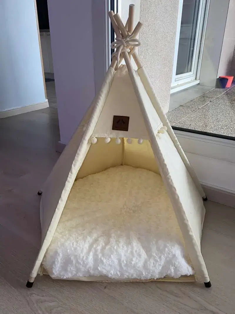 Cat relaxing inside a boho style nomad nook cat teepee tent.