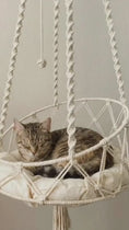 Load and play video in Gallery viewer, Boho Swing Macramé Hanging Cat Hammock in natural cotton rope, front angle view of elegant spiral ropes, a stylish cat tree alternative.
