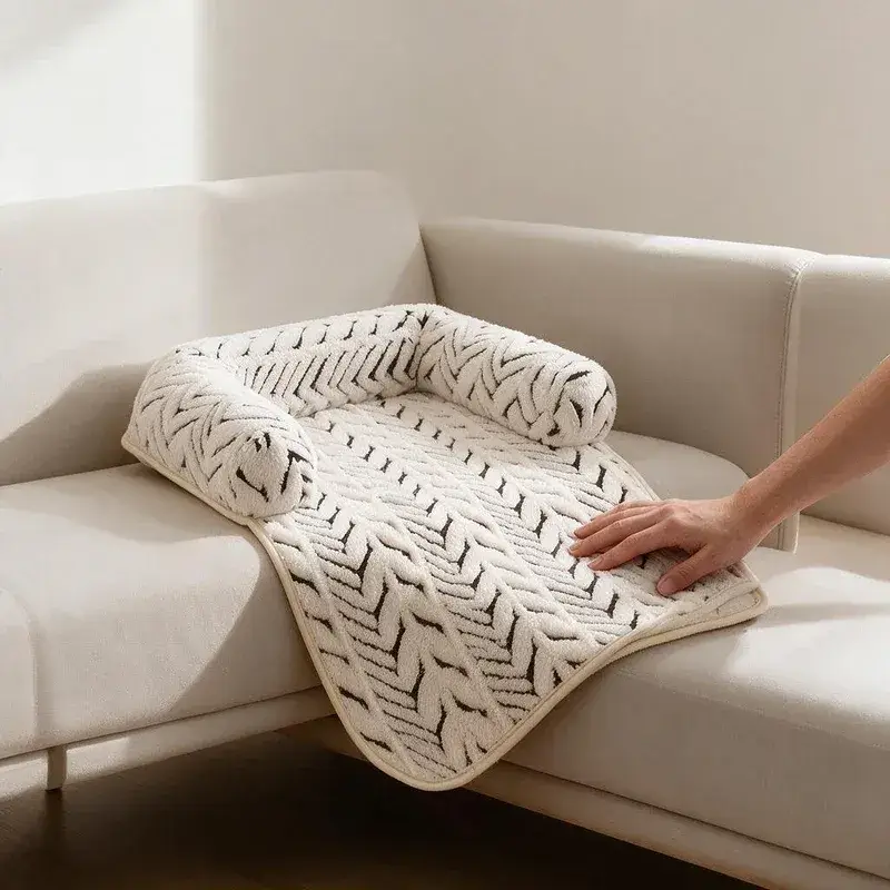 Hand smoothing The Sumi Lounger cat couch protector mat with raised bolsters on a cream sofa