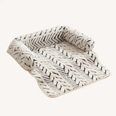 The Sumi Lounger washable cat bed for couch with raised bolsters in black and ivory zebra print