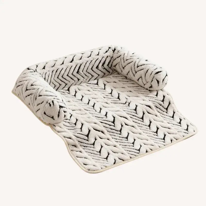 The Sumi Lounger washable cat bed for couch with raised bolsters in black and ivory zebra print