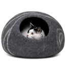 Cat inside Merino Cocoon dark grey wool felt cave — cozy felted cat hideaway, luxury cat bed