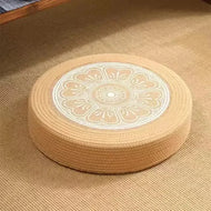 Tatami Zen Pouf in woven straw, angled view of the floral embroidered top, a breathable summer bed.