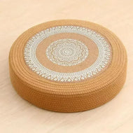 Tatami Zen Pouf in woven straw, close-up side view of the detailed mandala embroidery craftsmanship.